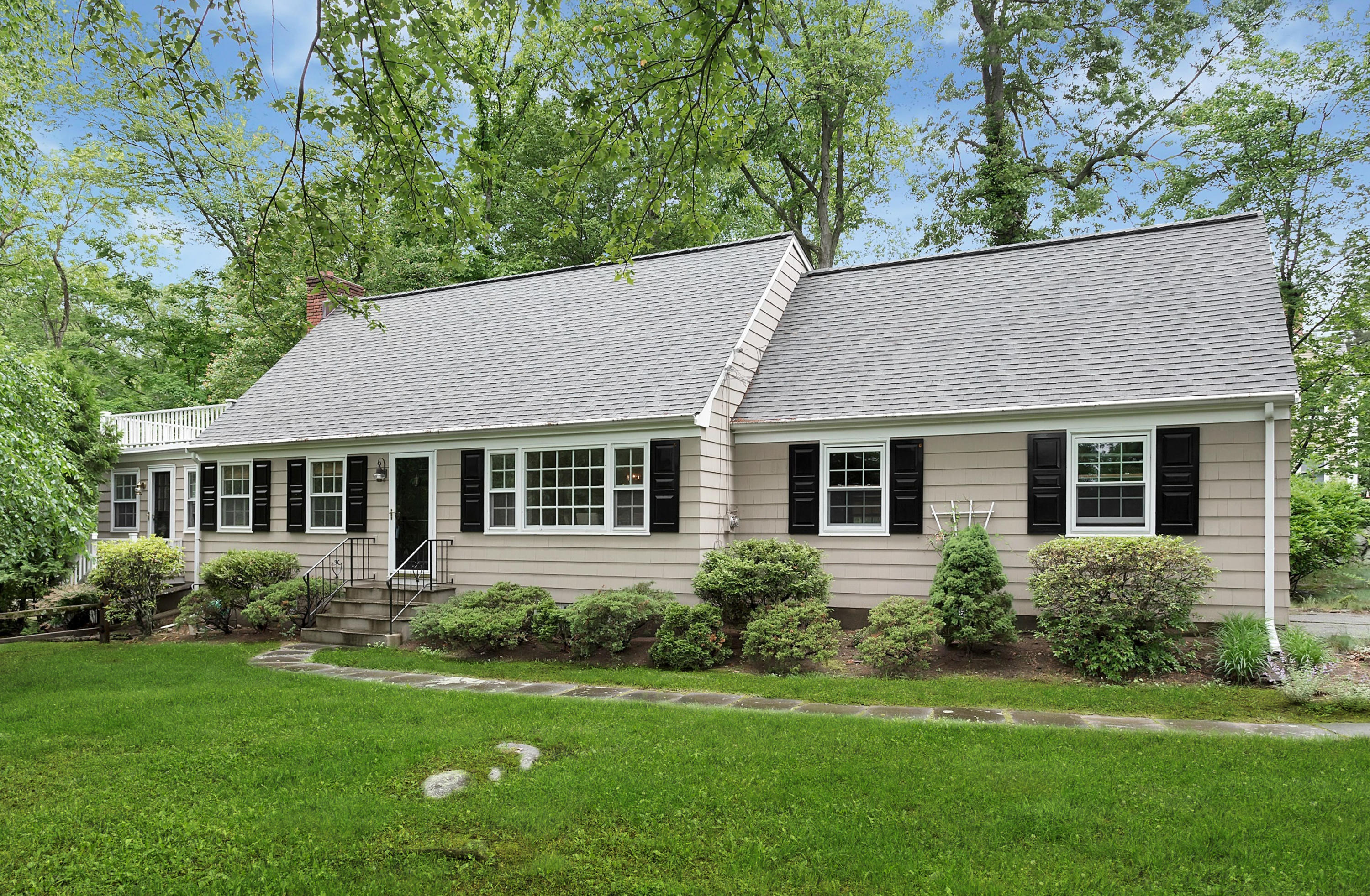 a aerial view of a house next to a big yard and large trees