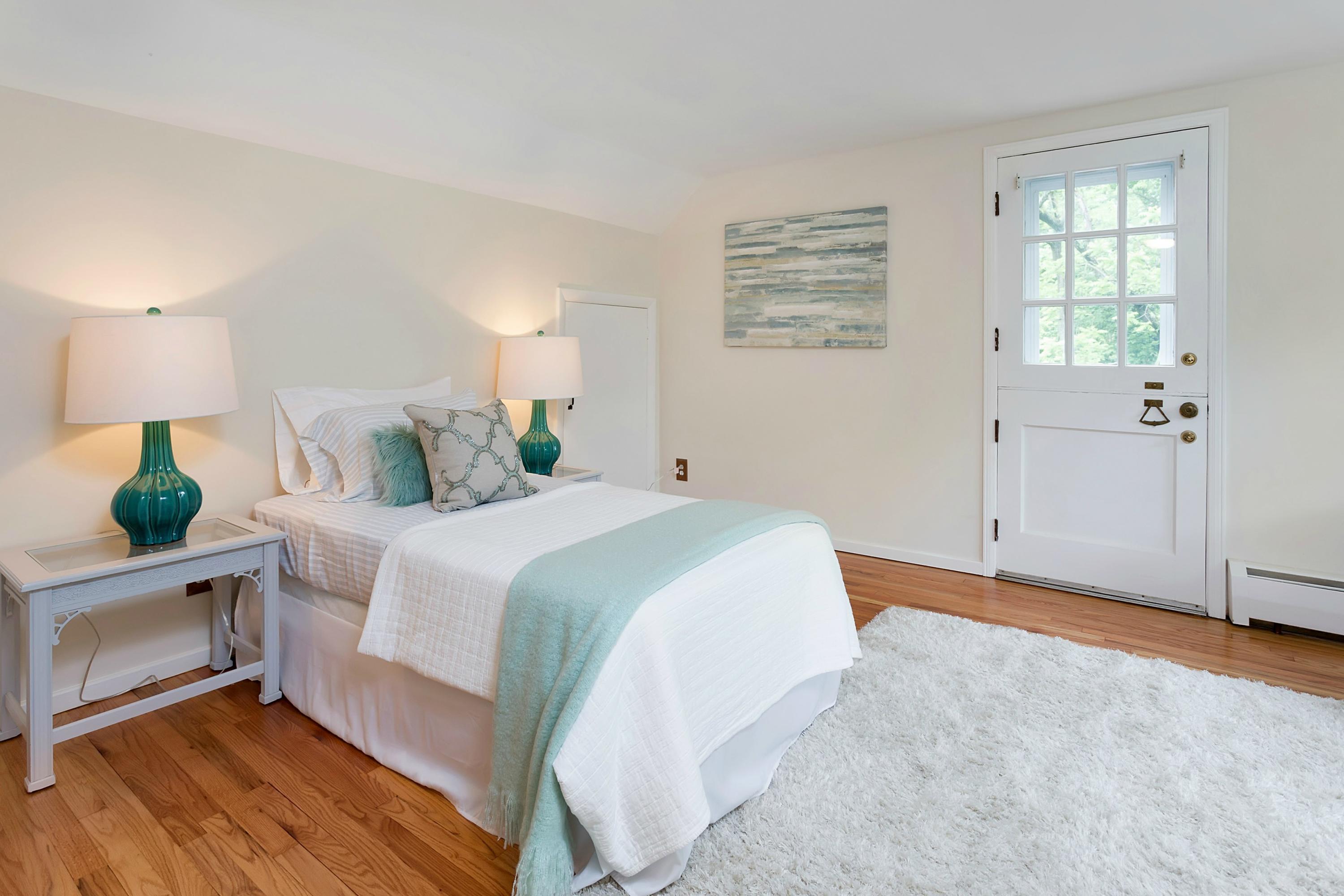 276 Smith Ridge Road New Canaan, CT 06840 - Photo 15 of 23 a bedroom with a large bed and wooden floor