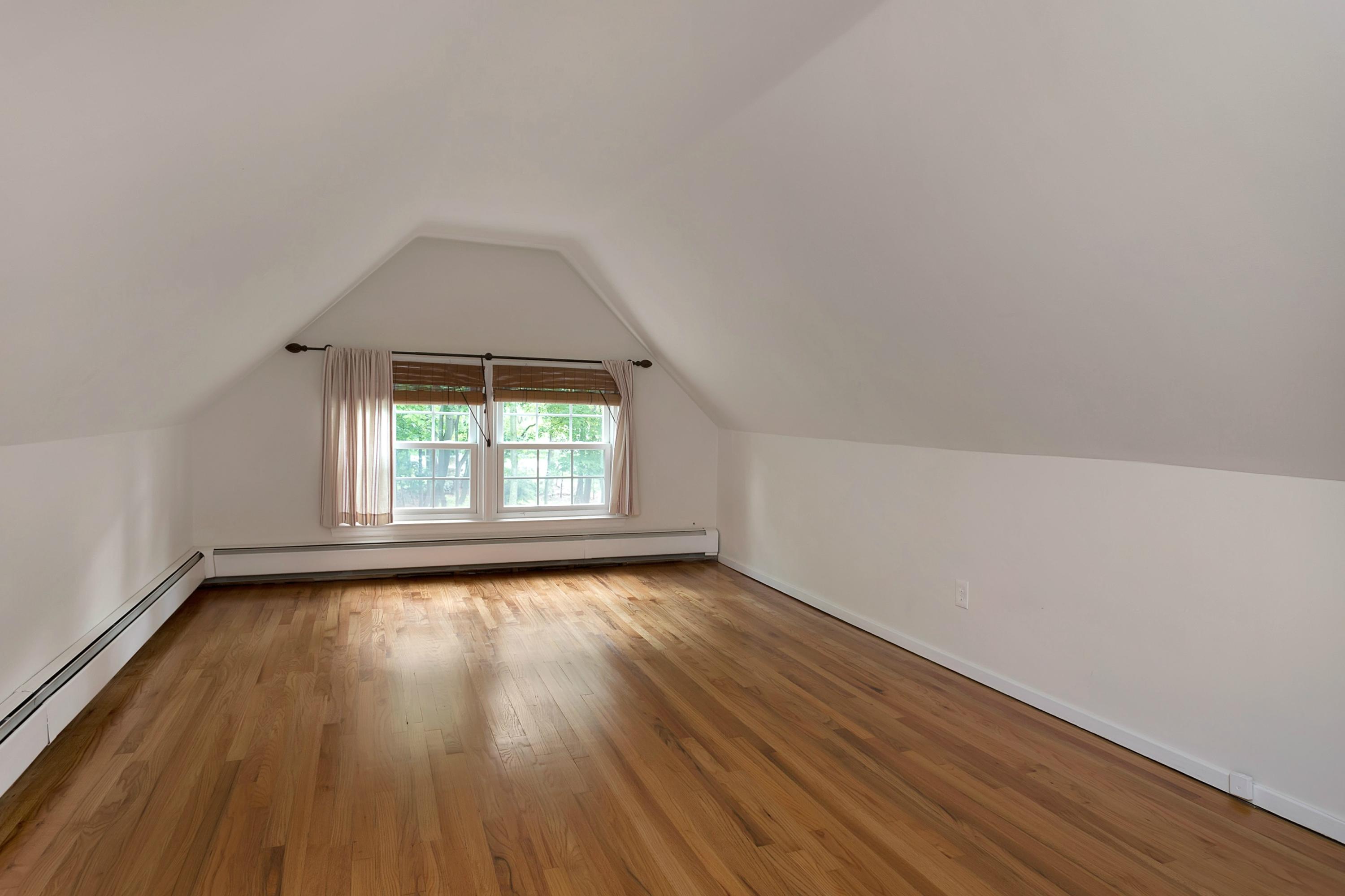 276 Smith Ridge Road New Canaan, CT 06840 - Photo 18 of 23 an empty room with wooden floor and windows