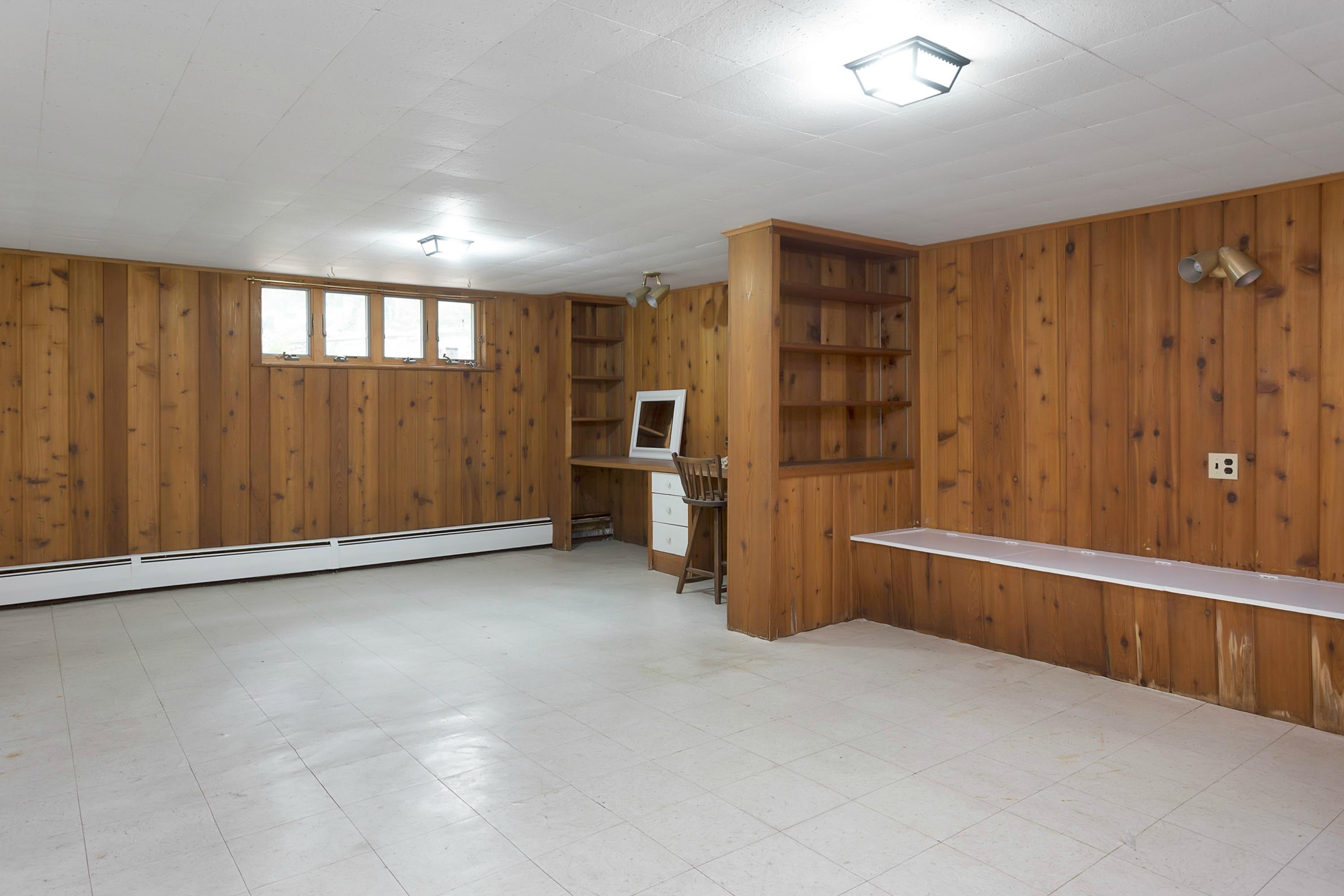 276 Smith Ridge Road New Canaan, CT 06840 - Photo 19 of 23 a view of an empty room with a cabinet and a window
