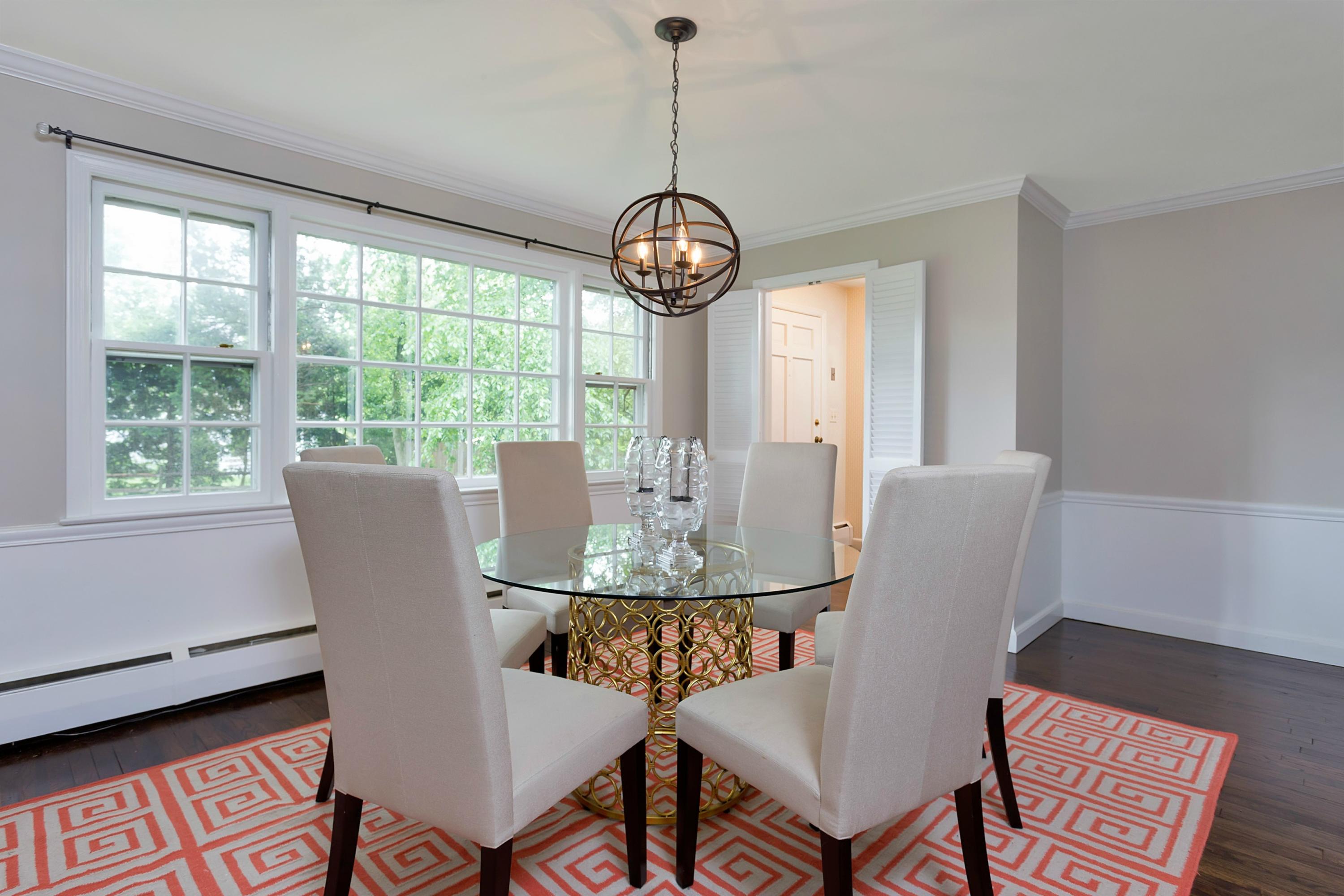 276 Smith Ridge Road New Canaan, CT 06840 - Photo 6 of 23 a view of a dining room with furniture wooden floor and a chandelier