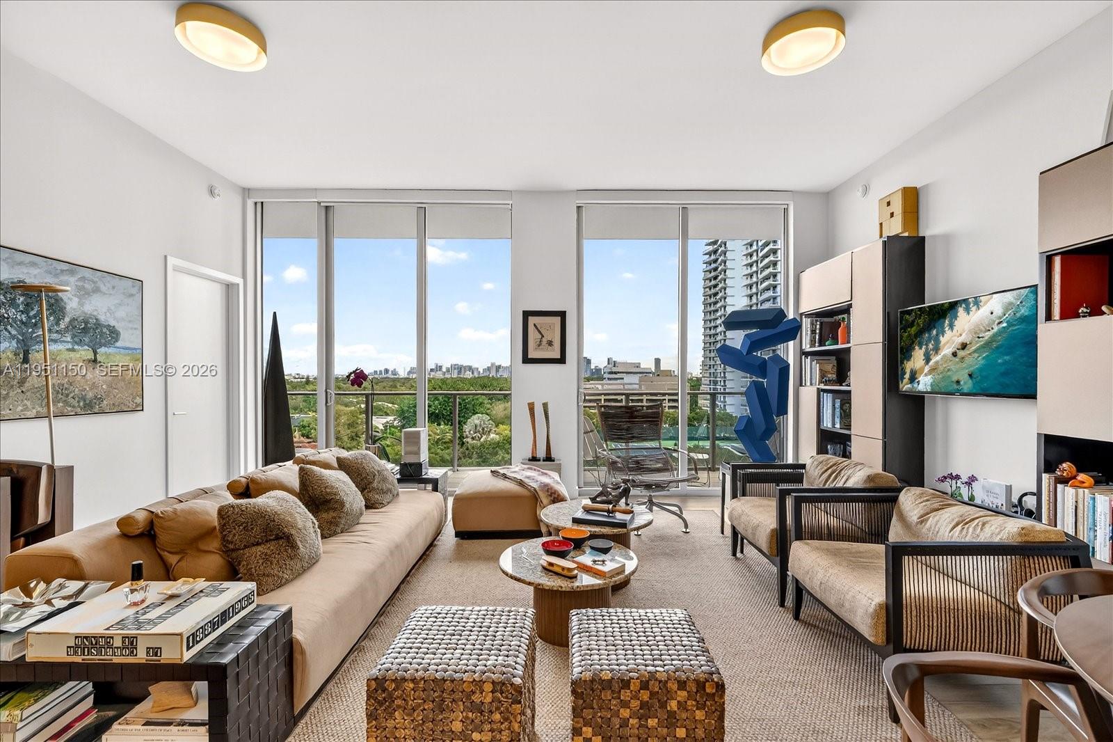 2678 Tigertail Avenue, Unit 604 Miami, FL 33133 - Photo 1 of 25 a living room with furniture and a floor to ceiling window