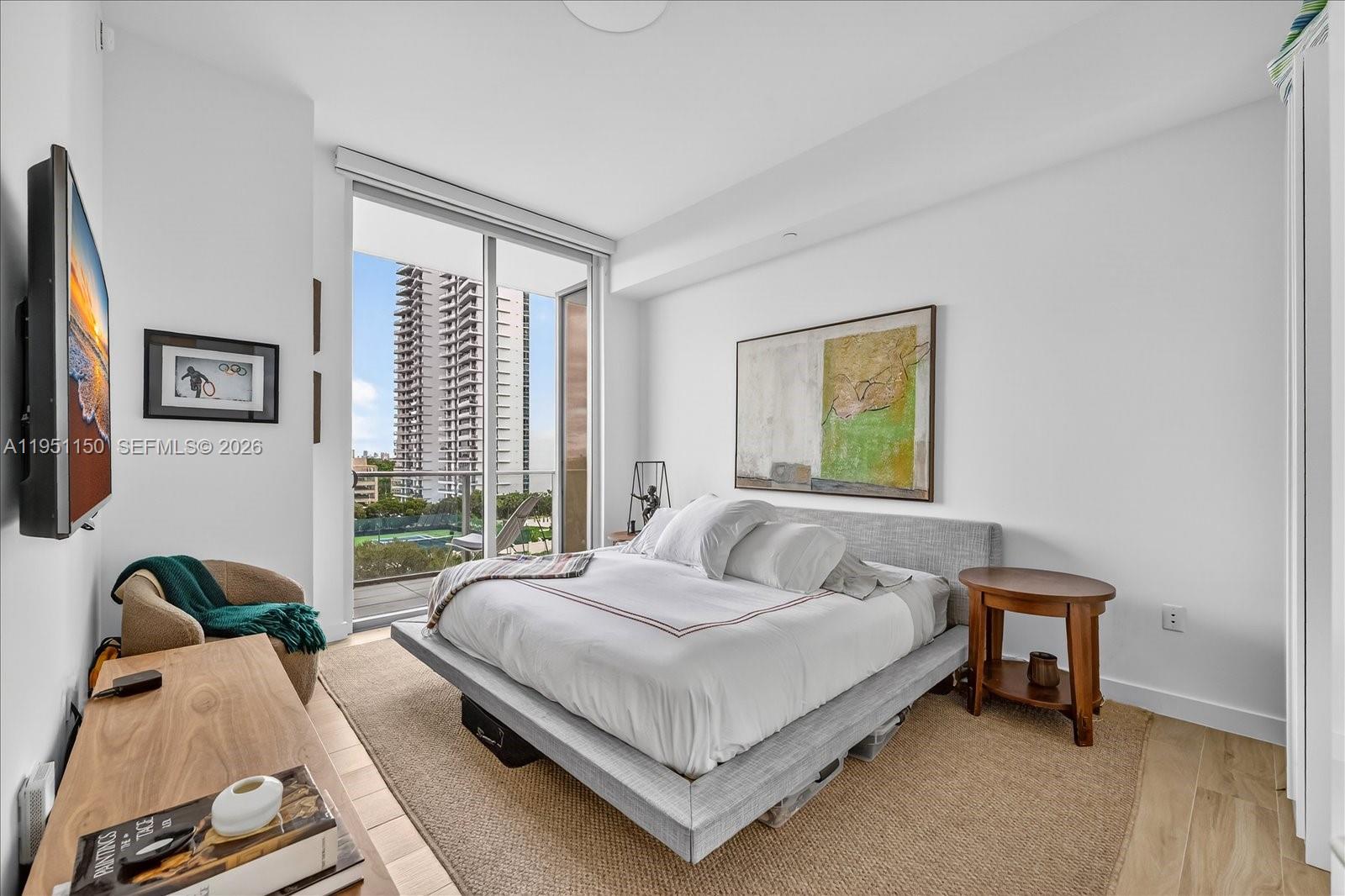 2678 Tigertail Avenue, Unit 604 Miami, FL 33133 - Photo 11 of 25 a bedroom with a bed and glass window