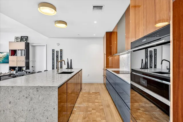 a kitchen with stainless steel appliances granite countertop a sink and cabinets