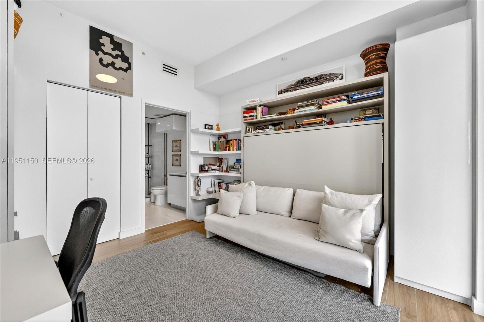 2678 Tigertail Avenue, Unit 604 Miami, FL 33133 - Photo 9 of 25 a bedroom with furniture and a painting on the wall