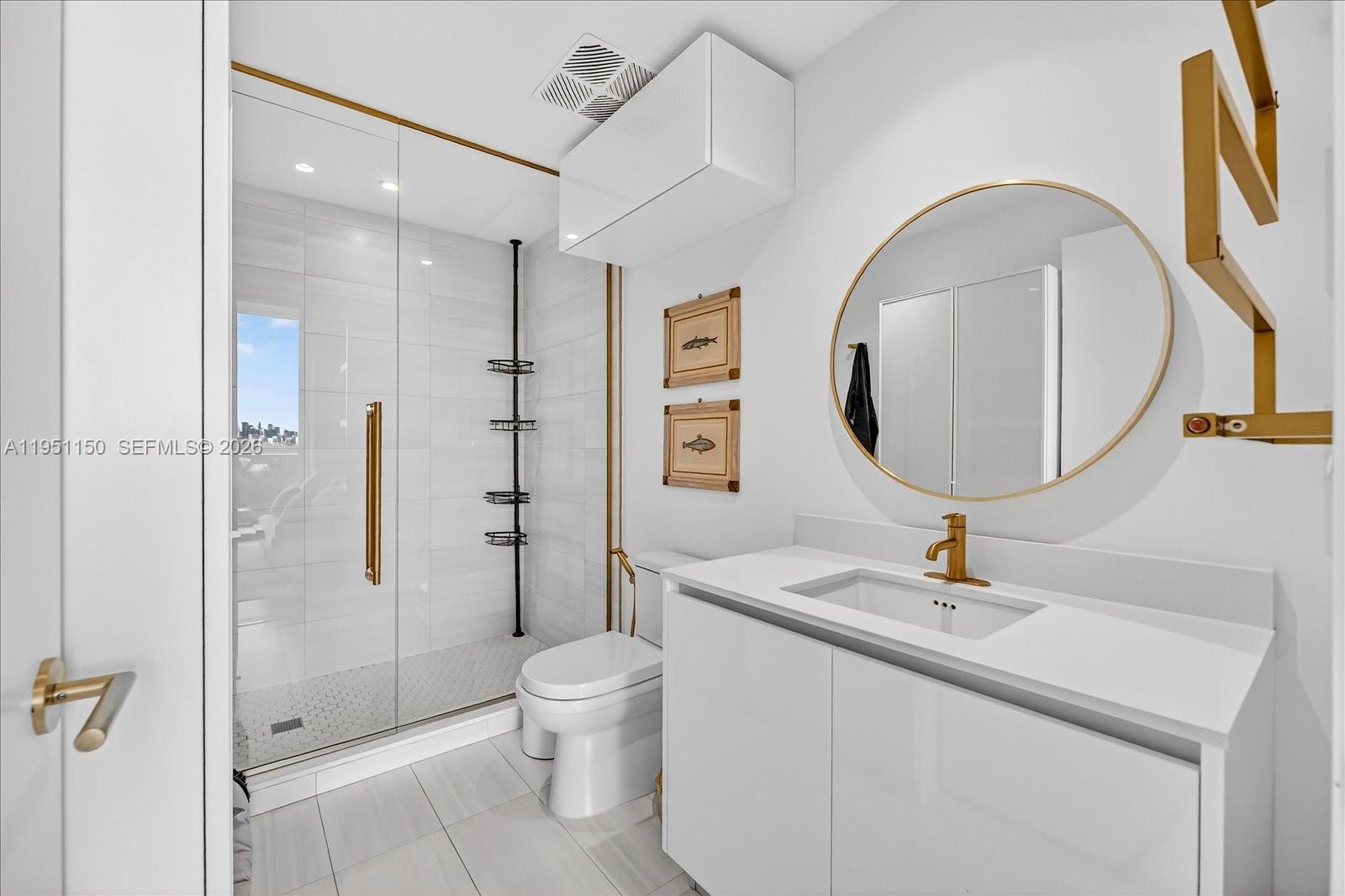 2678 Tigertail Avenue, Unit 604 Miami, FL 33133 - Photo 10 of 25 a bathroom with a sink toilet and shower