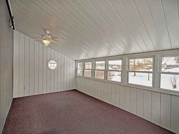 an empty room with windows and closet