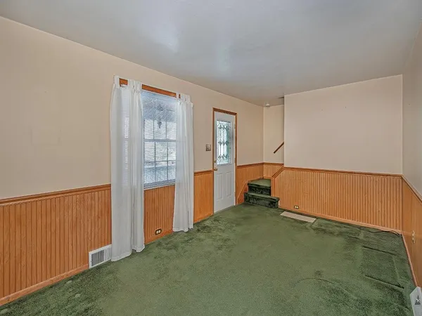 an empty room with windows and closet