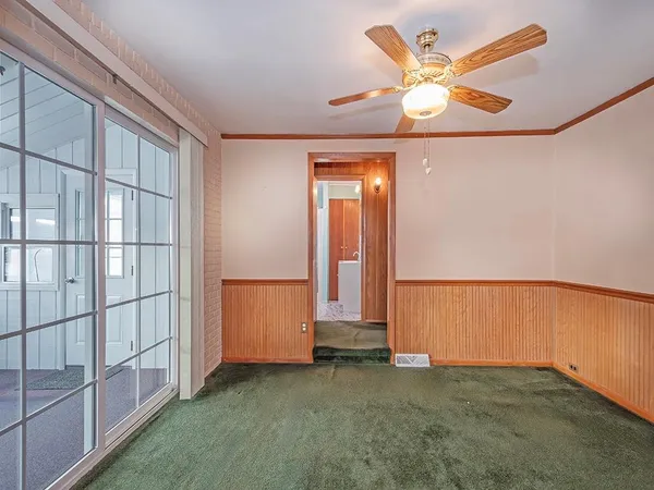 a kitchen with white cabinets and sink