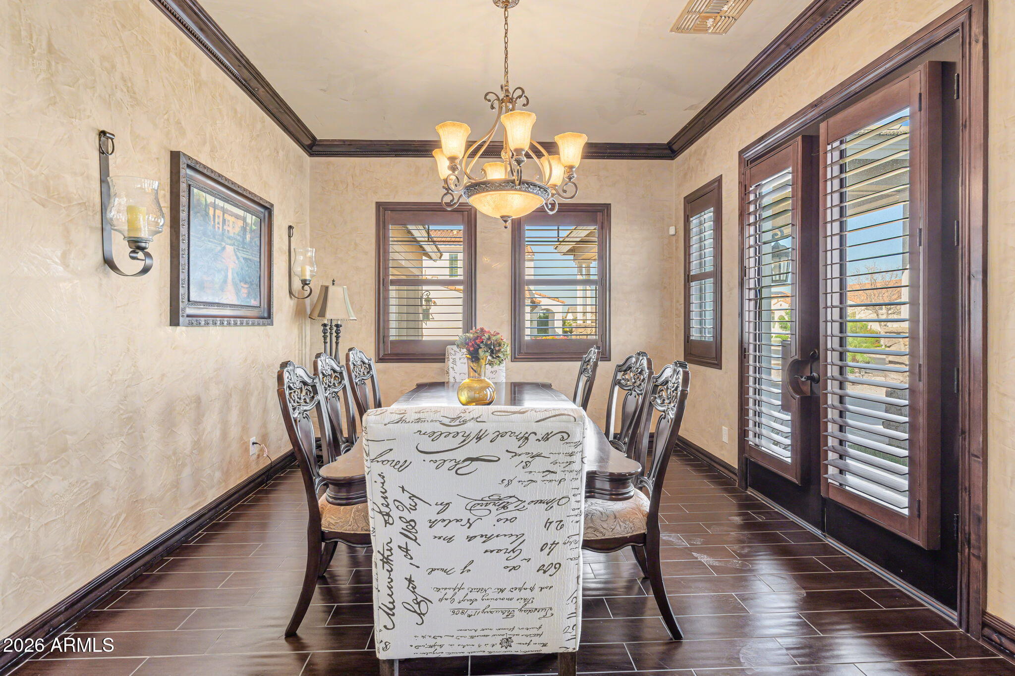 2822 East Constance Way Phoenix, AZ 85042 - Photo 12 of 64 a dining room with furniture a chandelier and wooden floor