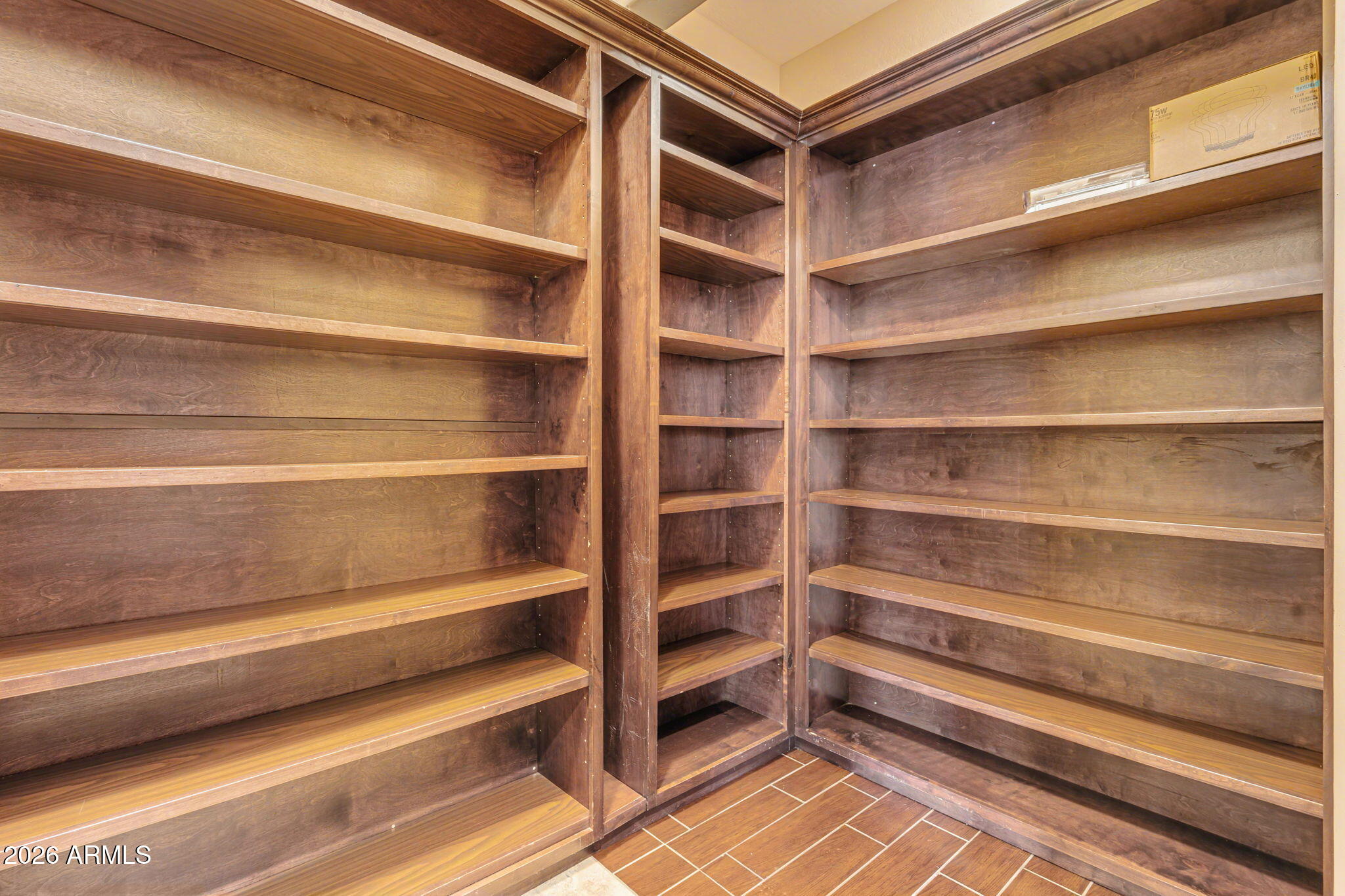 2822 East Constance Way Phoenix, AZ 85042 - Photo 17 of 64 a view of walk in closet with empty racks