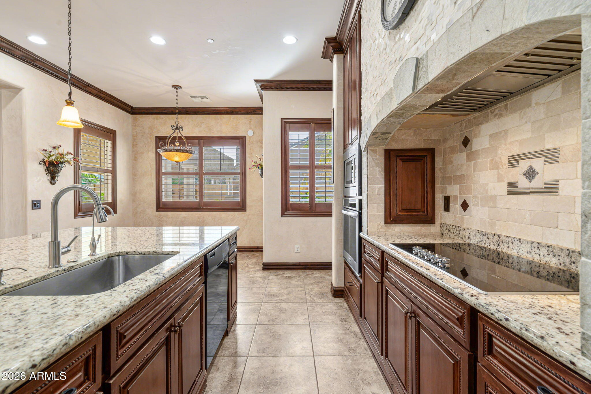 2822 East Constance Way Phoenix, AZ 85042 - Photo 22 of 64 a kitchen with granite countertop a sink and stove