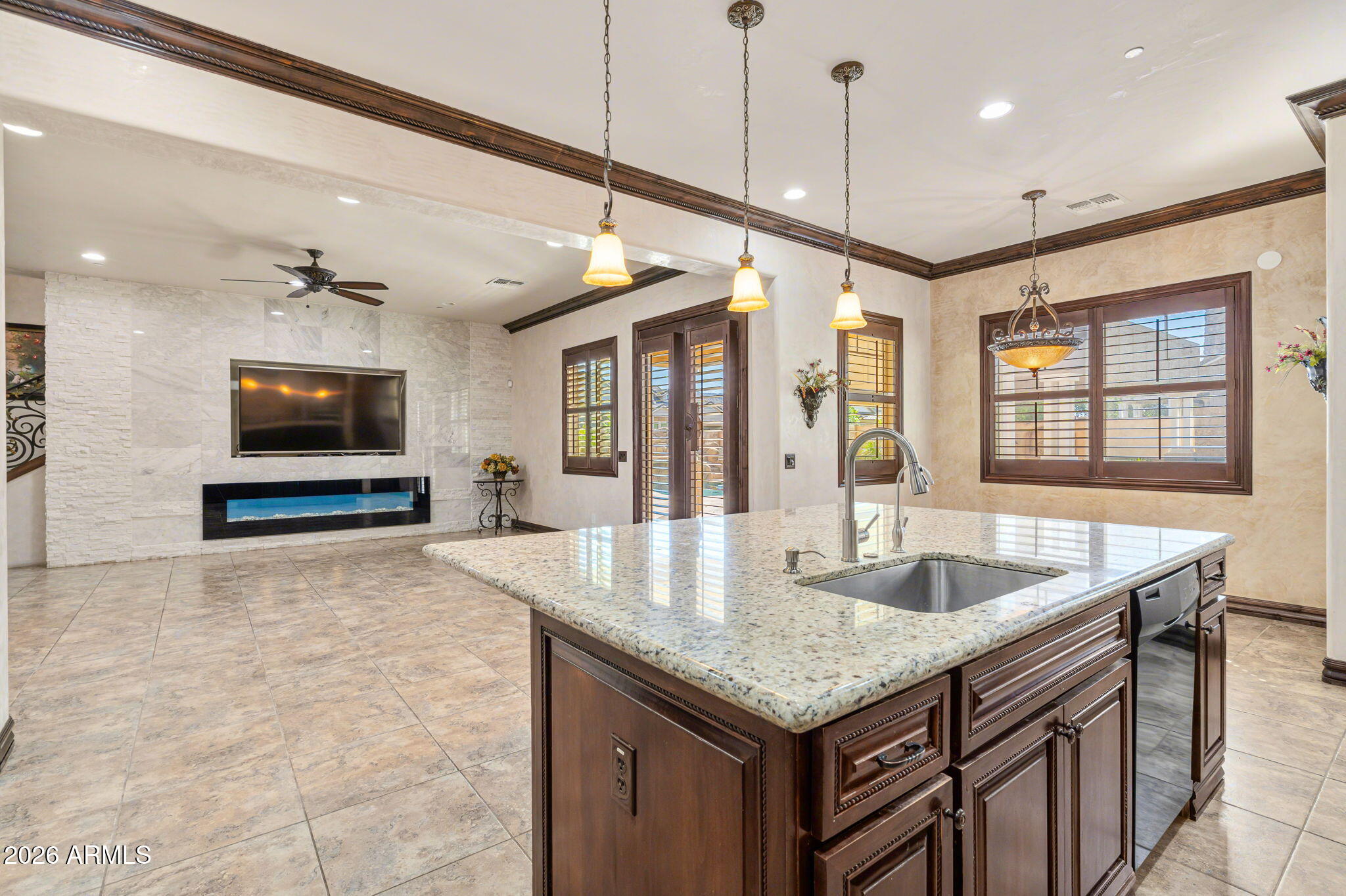 2822 East Constance Way Phoenix, AZ 85042 - Photo 23 of 64 a kitchen with granite countertop a sink and a flat screen tv
