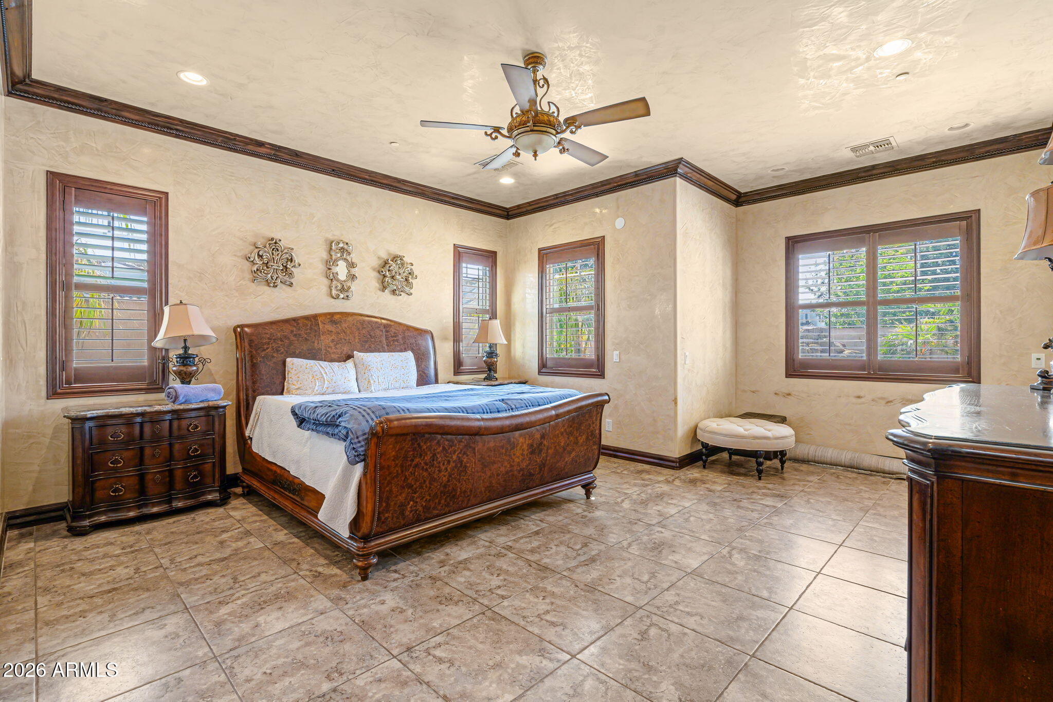 2822 East Constance Way Phoenix, AZ 85042 - Photo 31 of 64 a spacious bedroom with a bed and a table in it