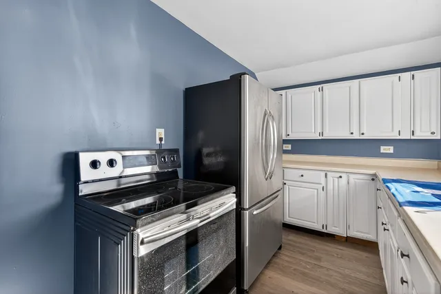 a kitchen with a stove and a refrigerator