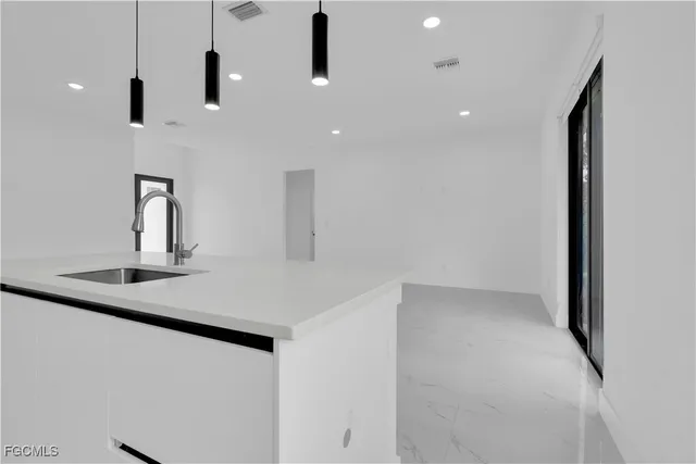 a kitchen with stainless steel appliances a sink and a refrigerator