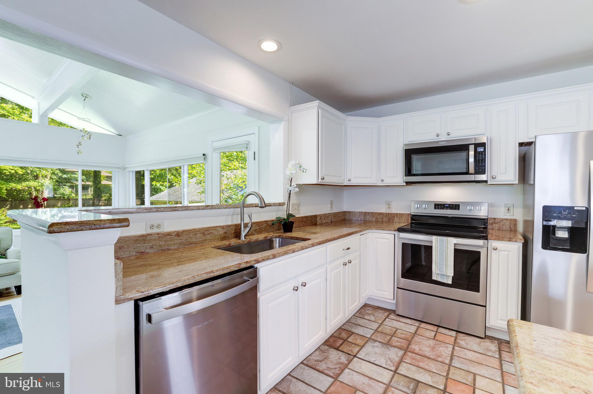 8305 Fort Hunt Road Alexandria, VA 22308 - Photo 19 of 74 a kitchen with stainless steel appliances granite countertop a stove a sink and a microwave
