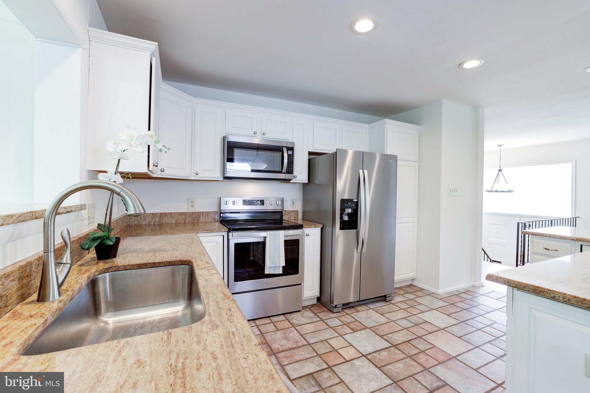 8305 Fort Hunt Road Alexandria, VA 22308 - Photo 20 of 74 a kitchen with stainless steel appliances a sink a stove a microwave a counter top space and cabinets