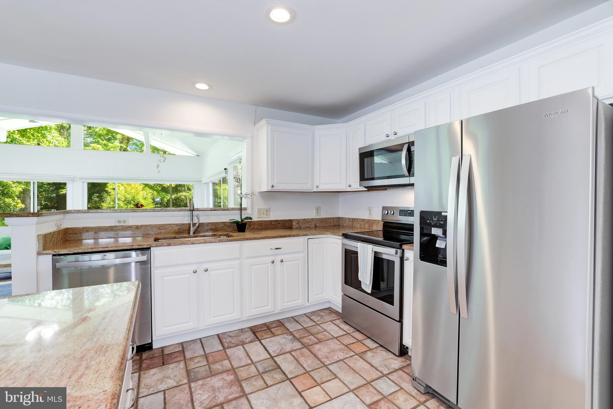 8305 Fort Hunt Road Alexandria, VA 22308 - Photo 27 of 74 a kitchen with stainless steel appliances granite countertop a stove a sink and a refrigerator