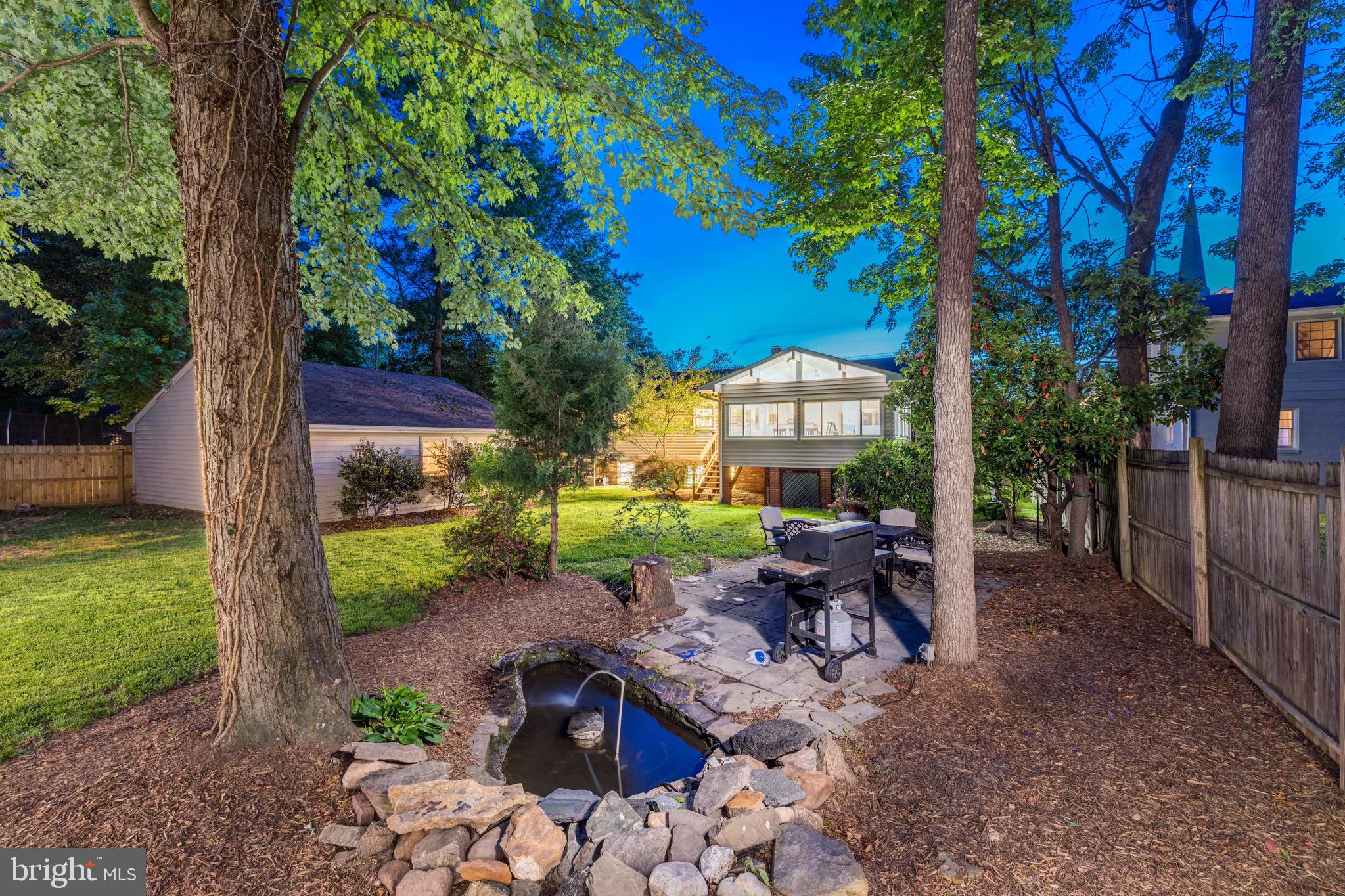 8305 Fort Hunt Road Alexandria, VA 22308 - Photo 4 of 74 a view of a patio with a table chairs and a fire pit