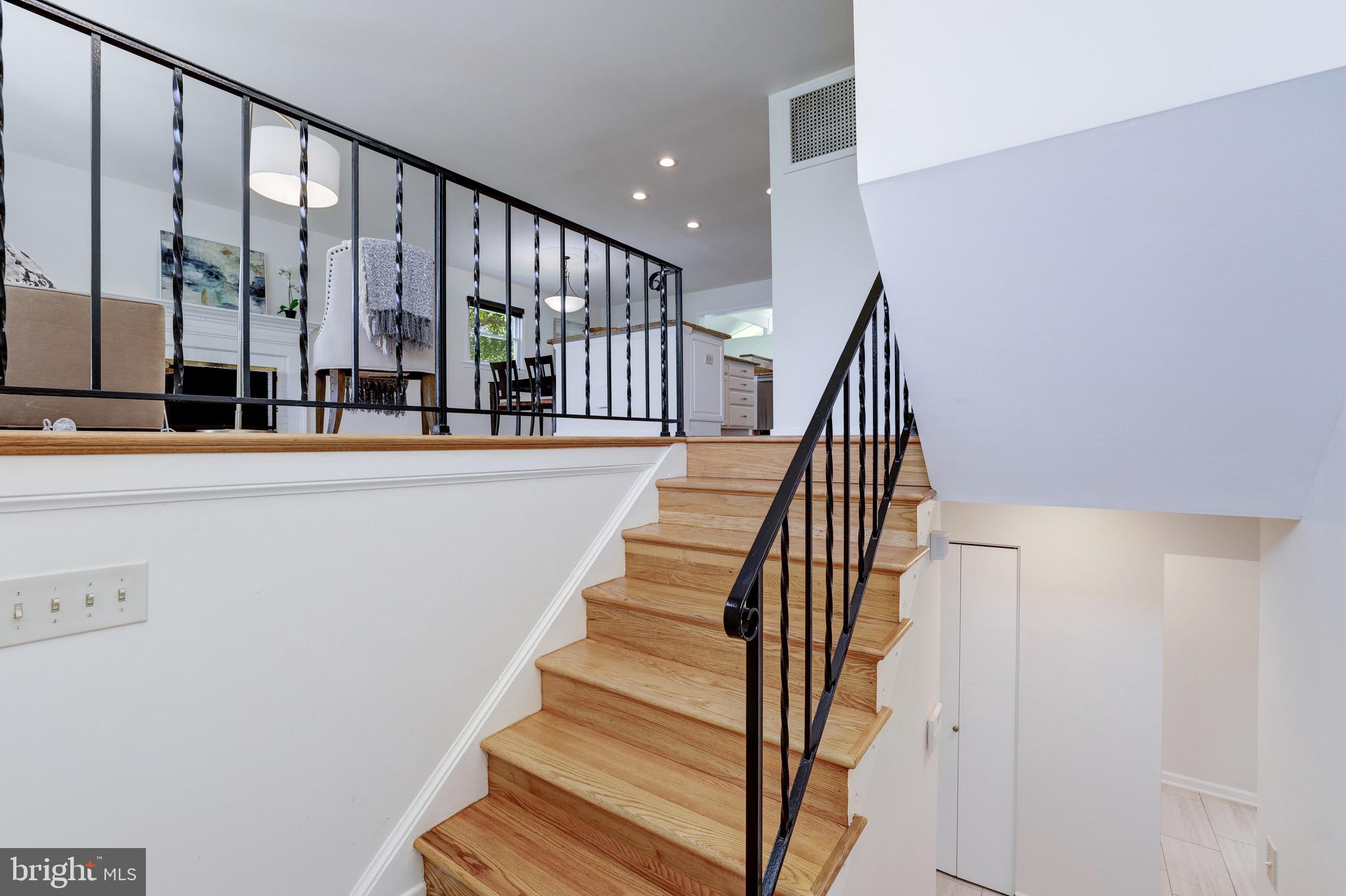 8305 Fort Hunt Road Alexandria, VA 22308 - Photo 43 of 74 a view of staircase with lots of frames on wall and a window