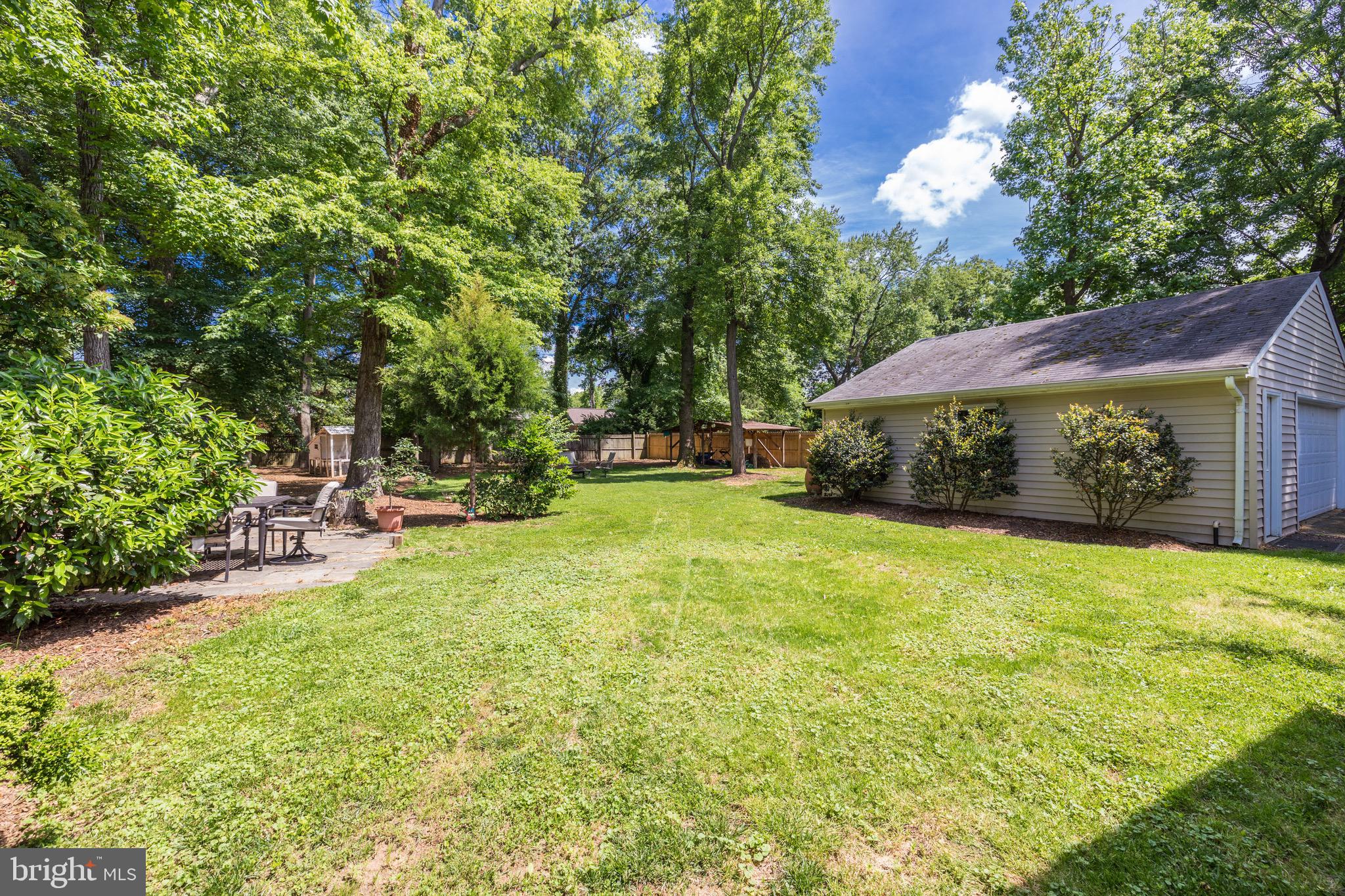 8305 Fort Hunt Road Alexandria, VA 22308 - Photo 59 of 74 a view of a patio with table and chairs under an umbrella