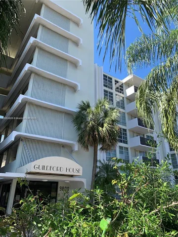 a view of a house with a flower garden