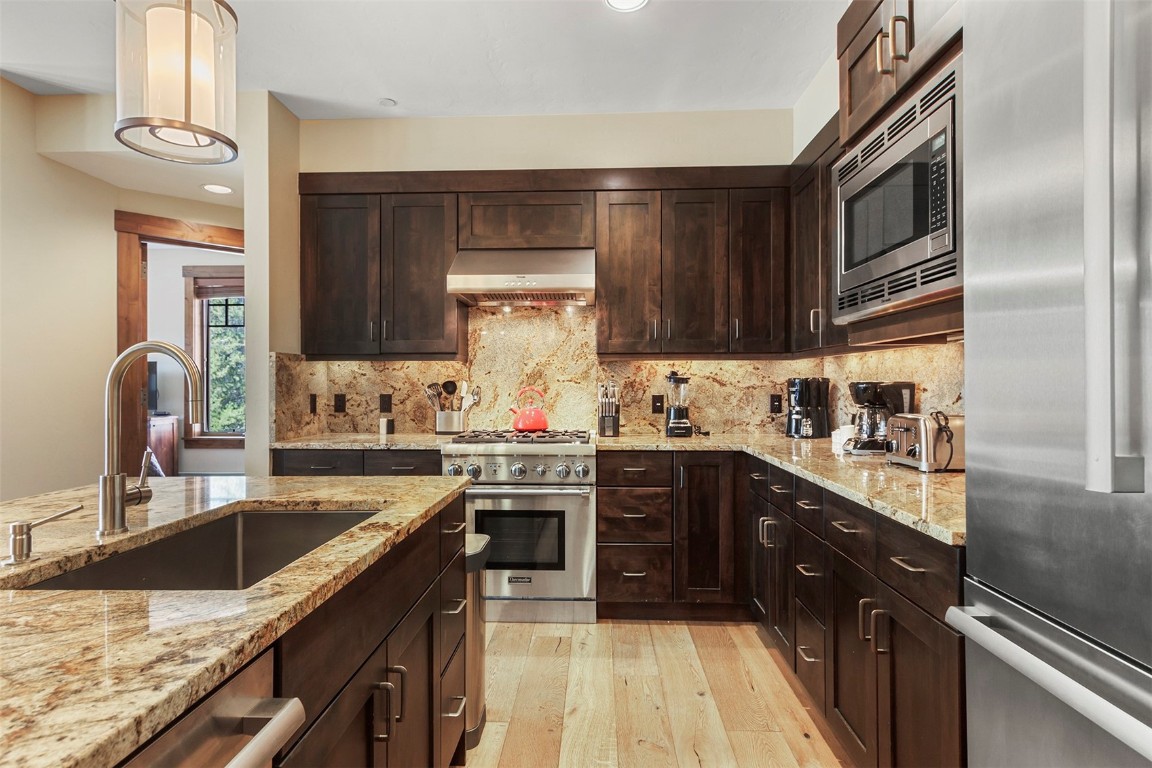 610 Columbine Road, Unit 6306 Breckenridge, CO 80424 - Photo 15 of 38 a kitchen with stainless steel appliances granite countertop a sink stove and refrigerator