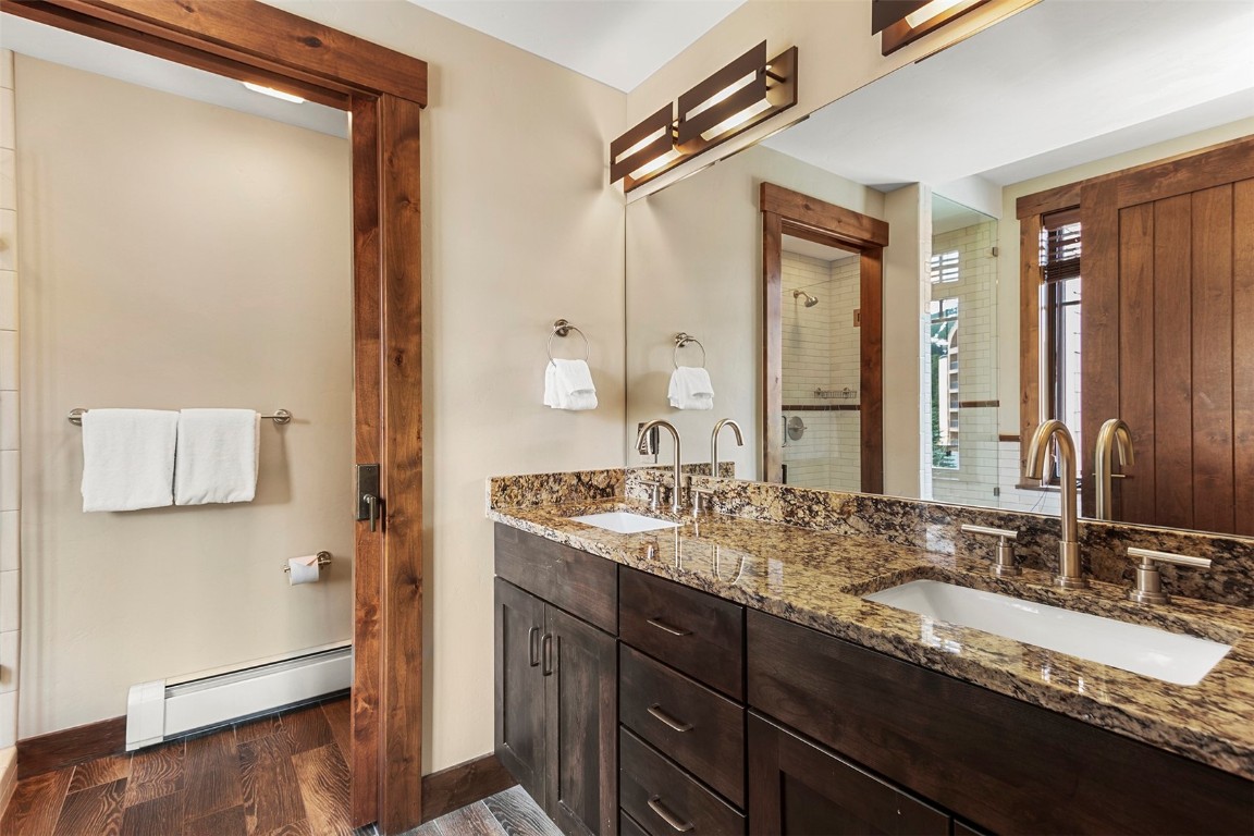610 Columbine Road, Unit 6306 Breckenridge, CO 80424 - Photo 20 of 38 a bathroom with a granite countertop double vanity sink and a mirror