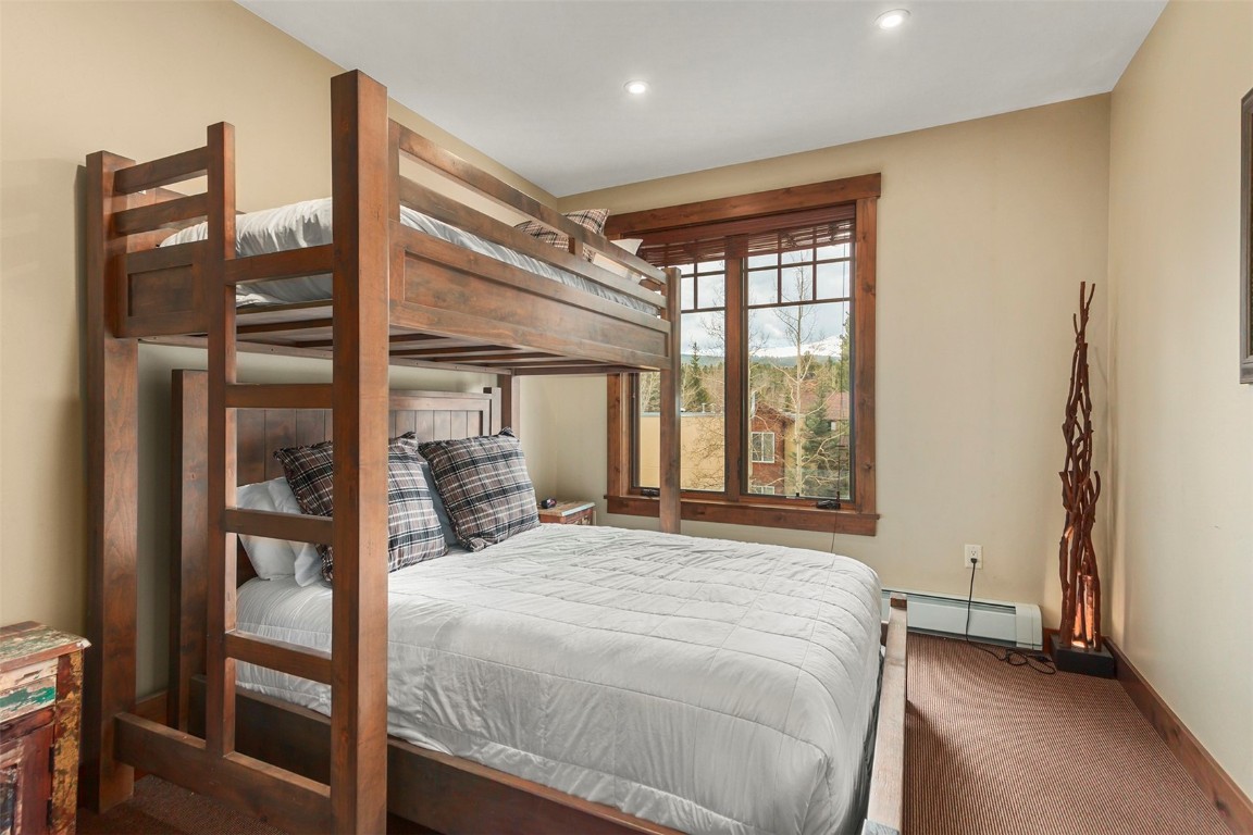 610 Columbine Road, Unit 6306 Breckenridge, CO 80424 - Photo 23 of 38 a large bed sitting in a bedroom next to a window