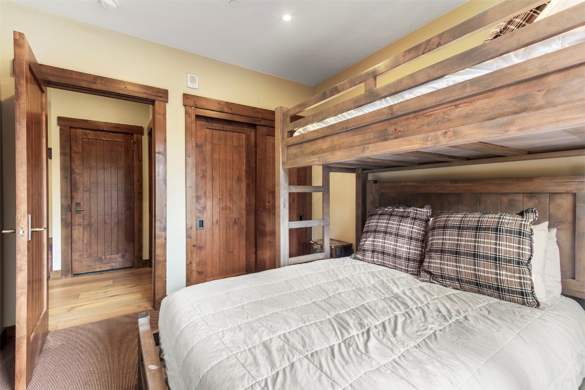 610 Columbine Road, Unit 6306 Breckenridge, CO 80424 - Photo 24 of 38 a bedroom with a bed and a dresser