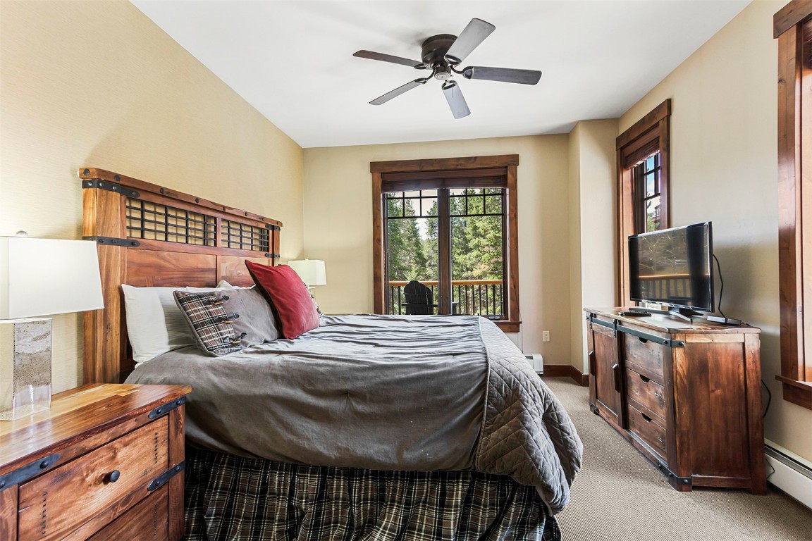 610 Columbine Road, Unit 6306 Breckenridge, CO 80424 - Photo 3 of 38 a bedroom with a bed and a flat screen tv