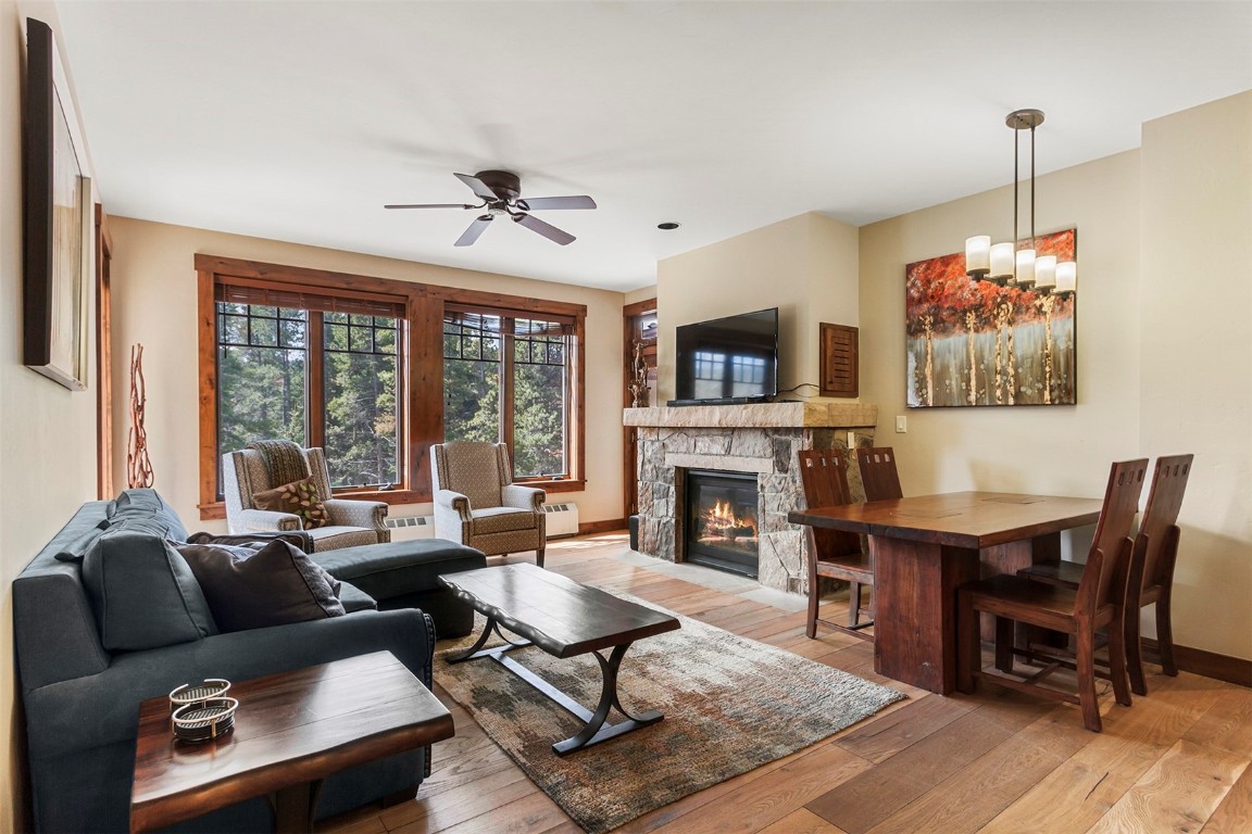 610 Columbine Road, Unit 6306 Breckenridge, CO 80424 - Photo 9 of 38 a living room with furniture a table and a fireplace