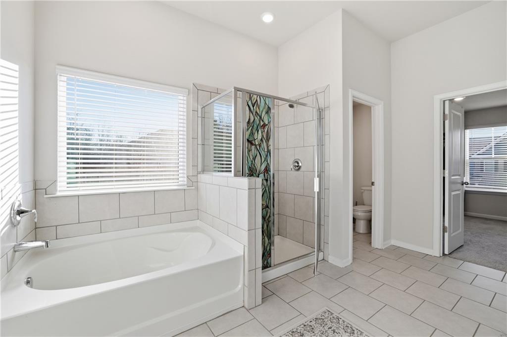 175 Paxton Lane Jefferson, GA 30549 - Photo 19 of 39 a bathroom with a bathtub and a shower