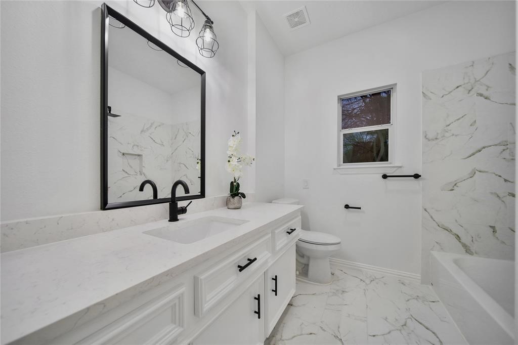 29602 Commons Forest Drive Huffman, TX 77336 - Photo 22 of 49 a bathroom with a sink a toilet and mirror