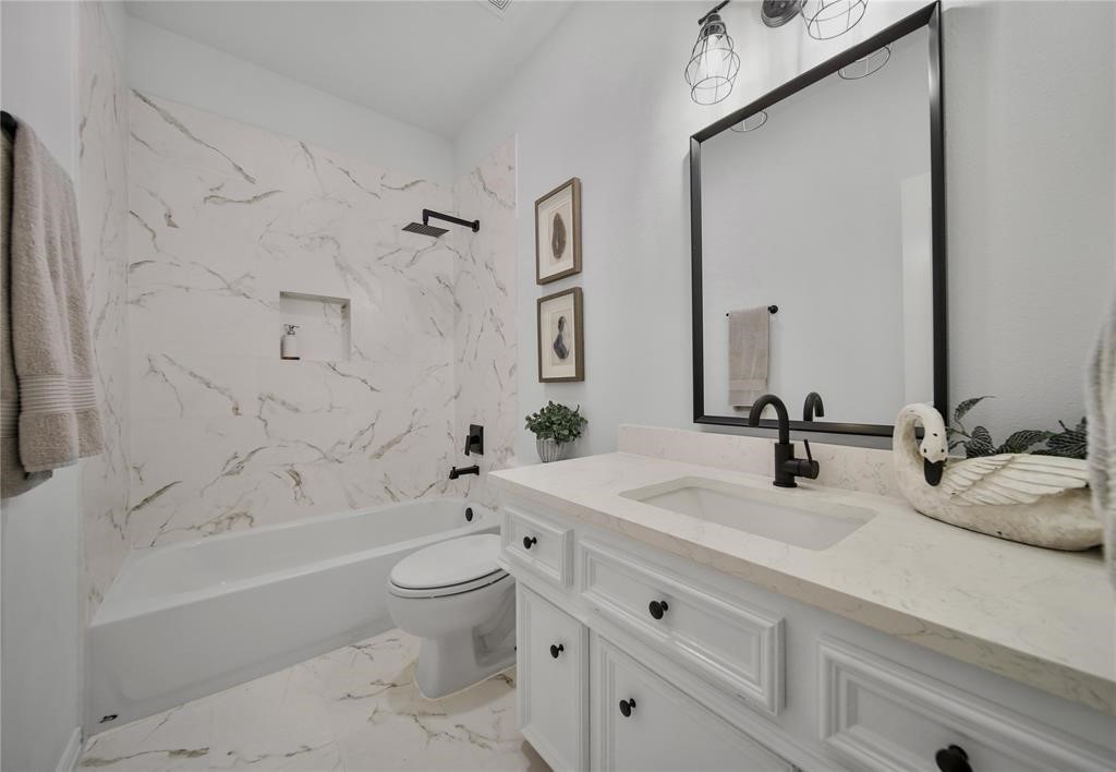29602 Commons Forest Drive Huffman, TX 77336 - Photo 25 of 49 a bathroom with a double vanity sink toilet and shower