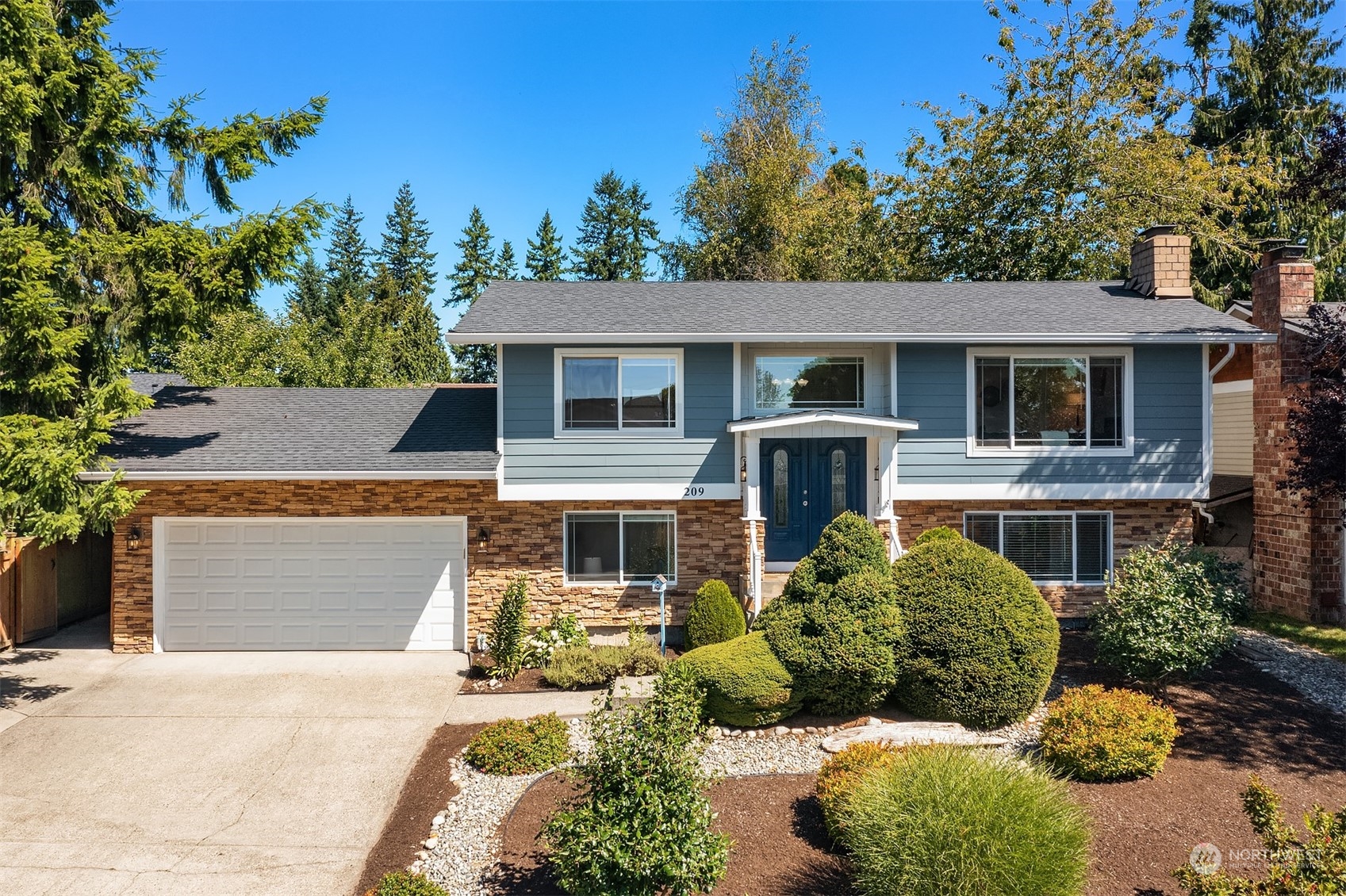 209 225th Place Southwest Bothell, WA 98021 - Photo 1 of 29 front view of a house with a garden