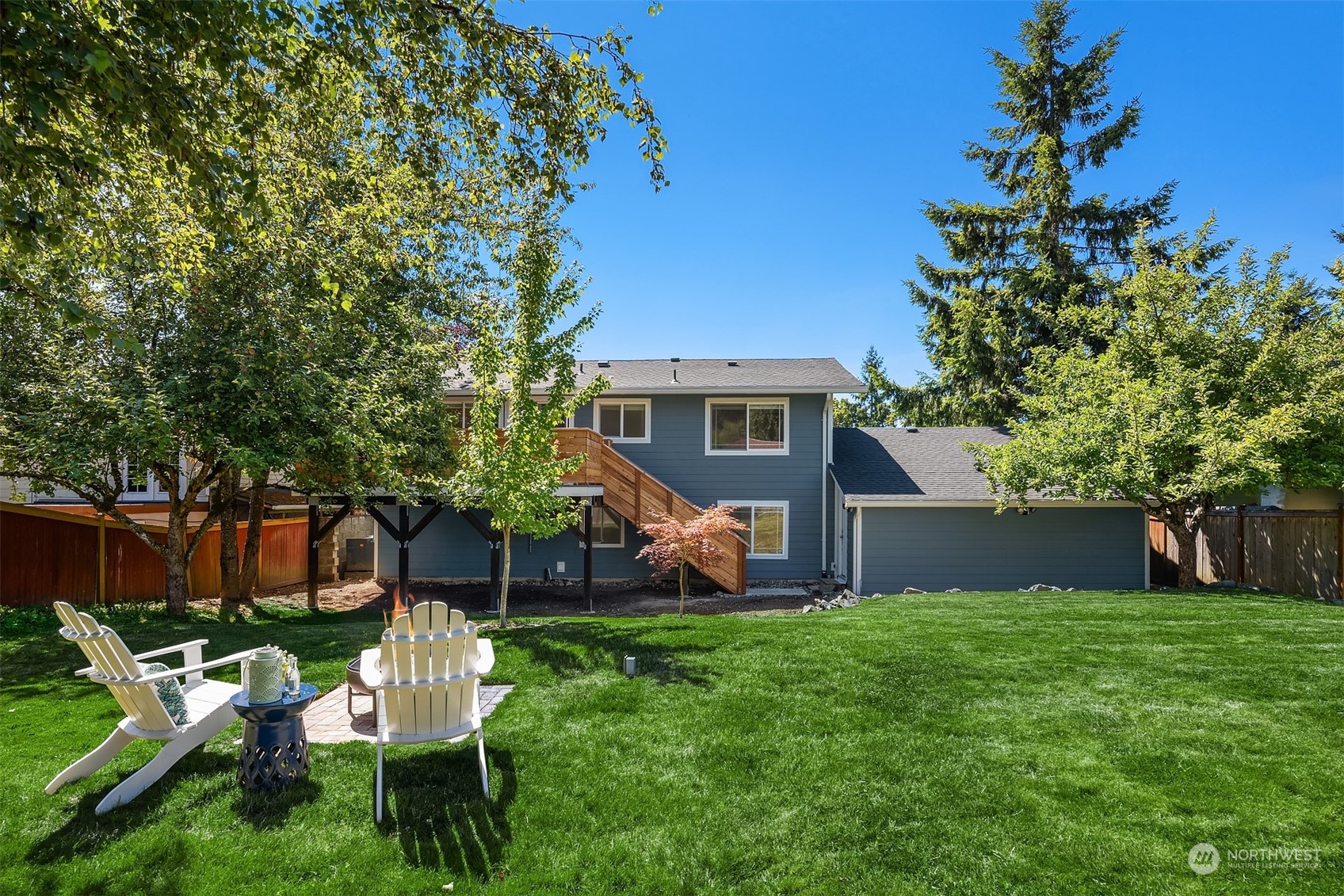 209 225th Place Southwest Bothell, WA 98021 - Photo 13 of 29 a view of a chair and table in backyard of the house
