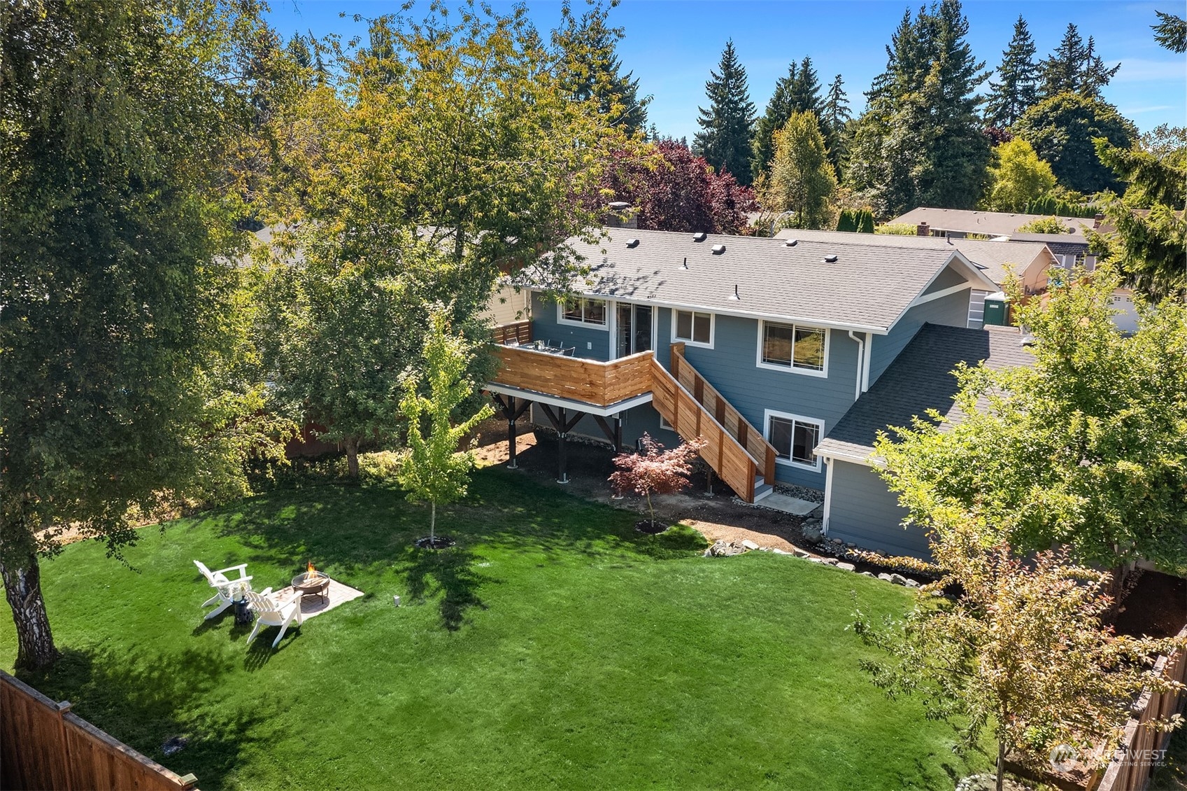 209 225th Place Southwest Bothell, WA 98021 - Photo 2 of 29 a aerial view of a house with a big yard and large trees