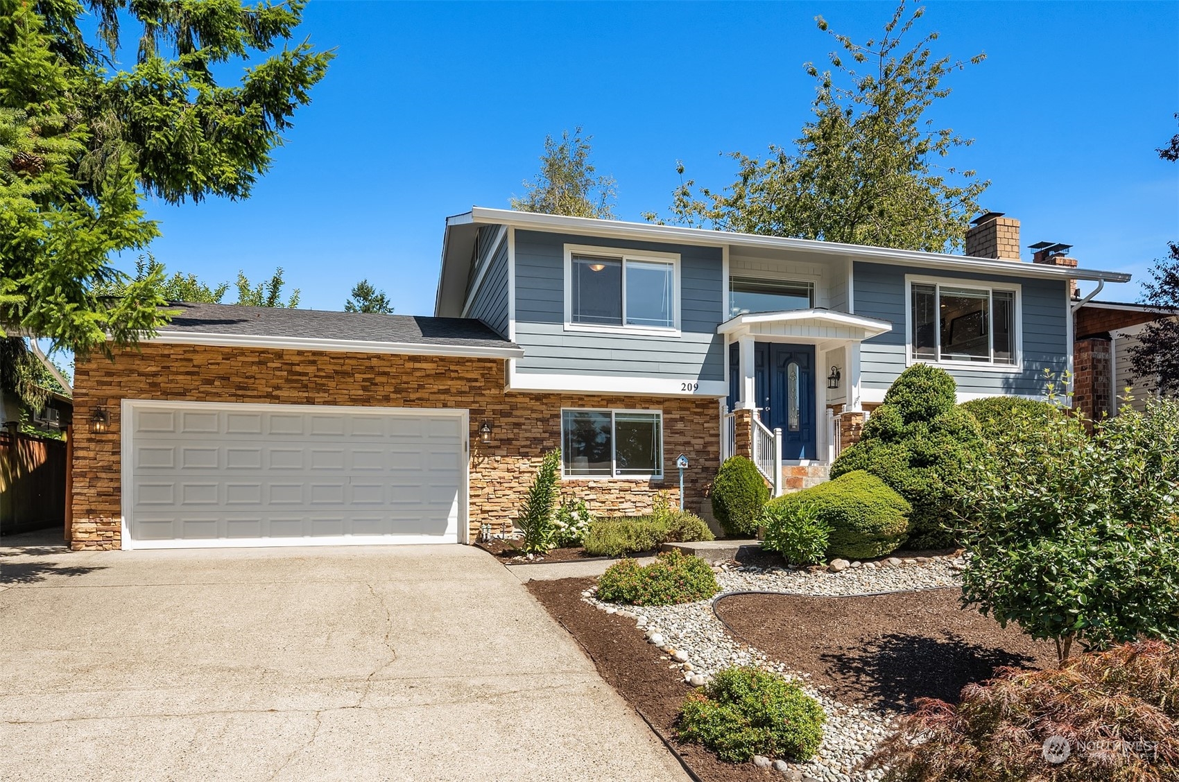 209 225th Place Southwest Bothell, WA 98021 - Photo 29 of 29 a front view of a house with garden