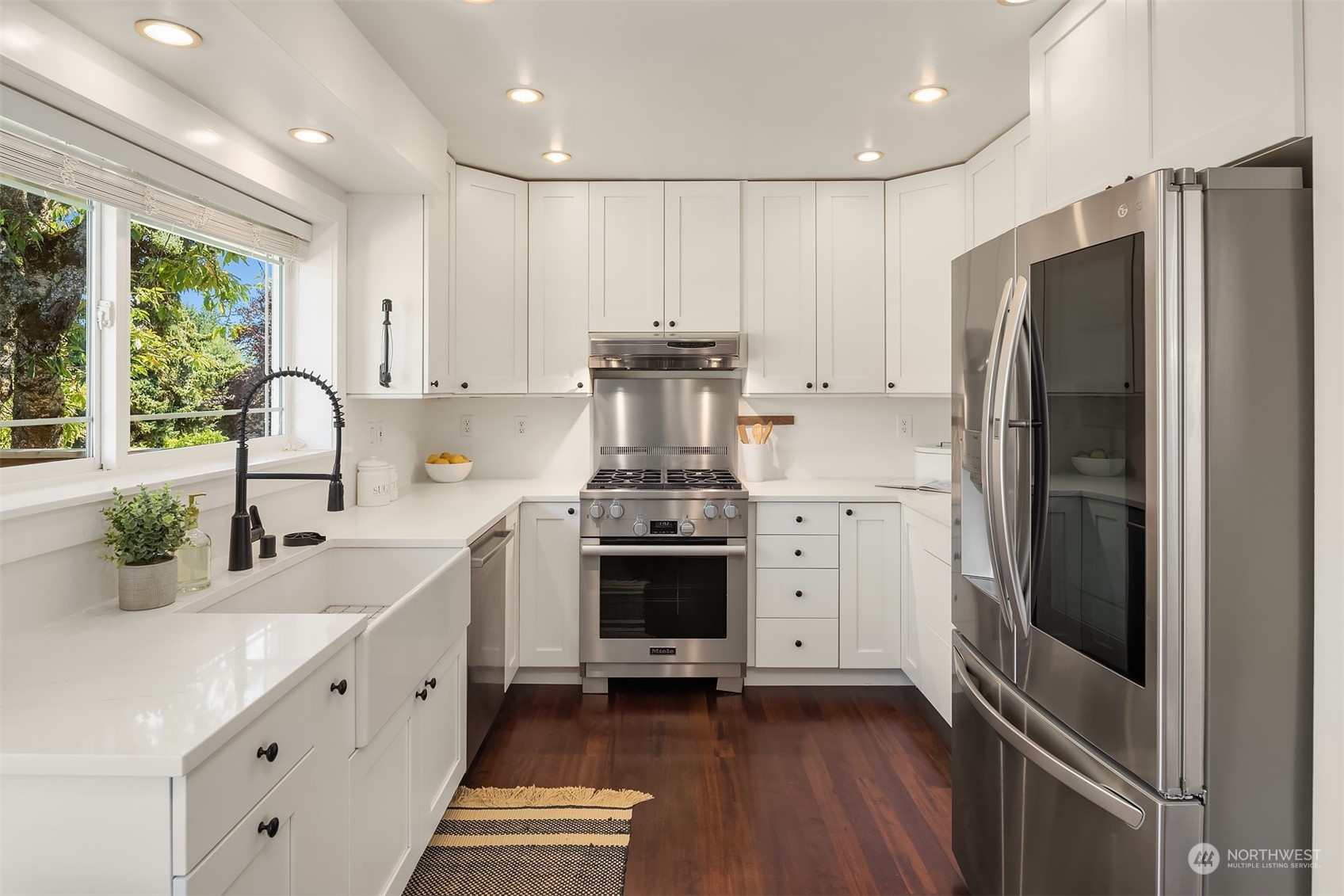 209 225th Place Southwest Bothell, WA 98021 - Photo 9 of 29 a kitchen with granite countertop a refrigerator stove and sink