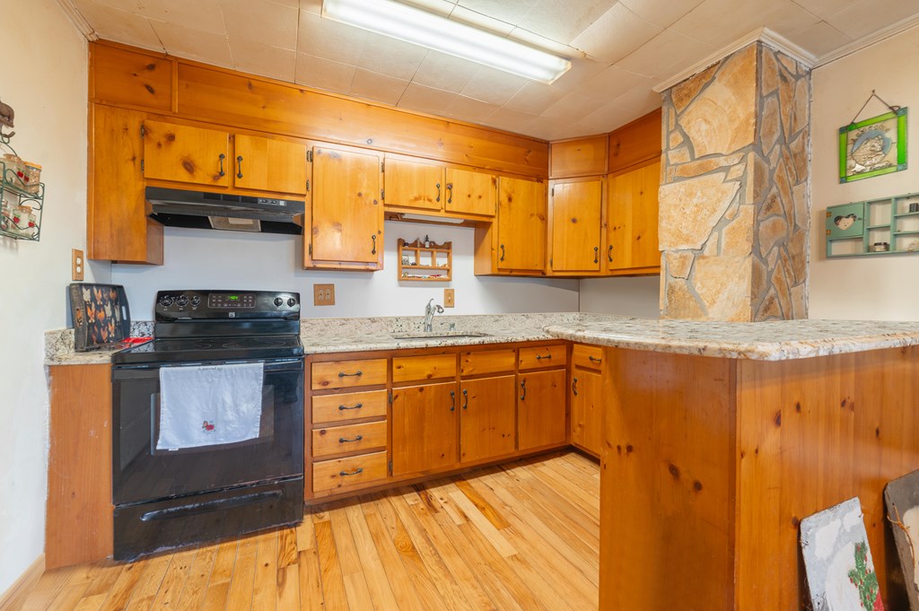 133 TJ Lane Murphy, NC 28906 - Photo 14 of 23 a kitchen with granite countertop cabinets stainless steel appliances and a counter space