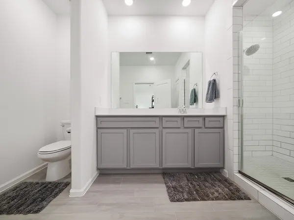 a bathroom with a sink a toilet and a mirror