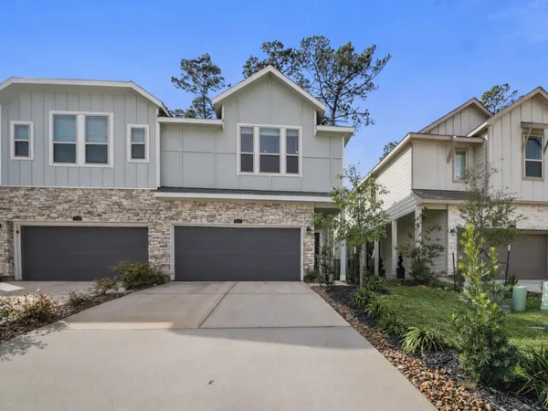 a front view of a house with a yard and a garage