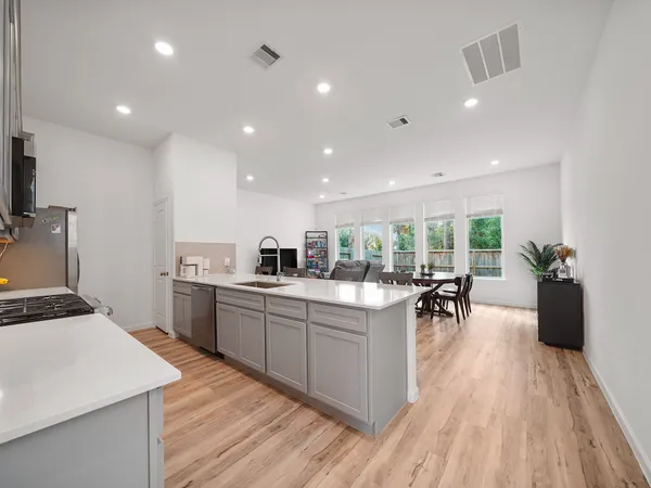 a kitchen with a sink a counter top space and appliances