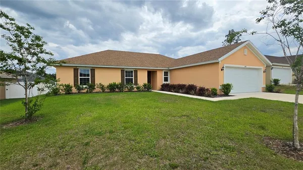 a front view of house with yard and green space