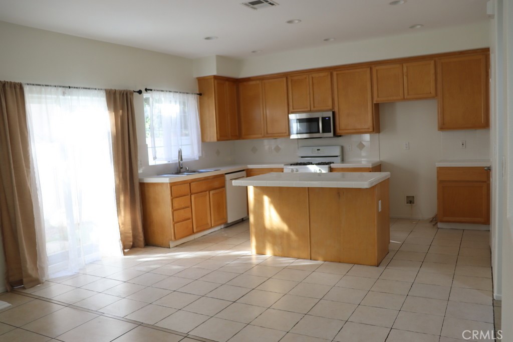 16731 Parthenia Street, Unit 3 Northridge, CA 91343 - Photo 20 of 37 a kitchen with stainless steel appliances granite countertop a sink stove and refrigerator