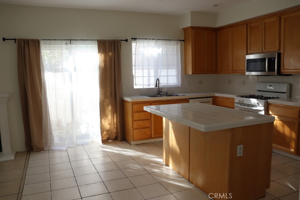 16731 Parthenia Street, Unit 3 Northridge, CA 91343 - Photo 21 of 37 a kitchen with a sink a stove and a refrigerator
