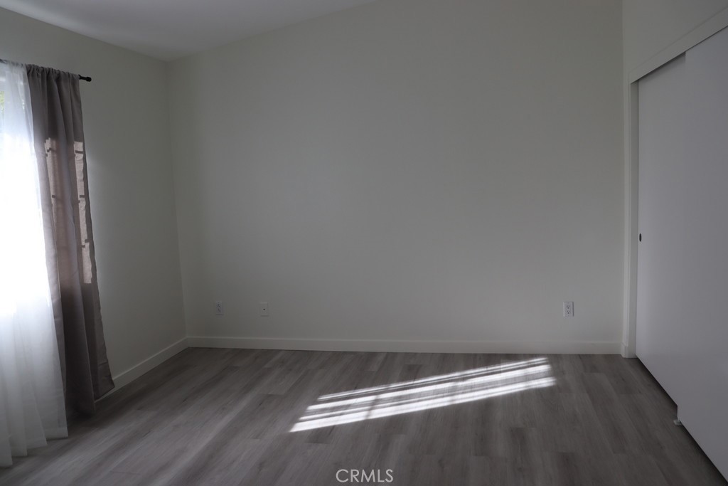 16731 Parthenia Street, Unit 3 Northridge, CA 91343 - Photo 29 of 37 a view of a small space with wooden floor and a window
