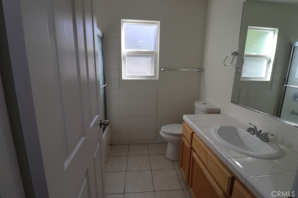 16731 Parthenia Street, Unit 3 Northridge, CA 91343 - Photo 34 of 37 a bathroom with a sink a toilet and tub